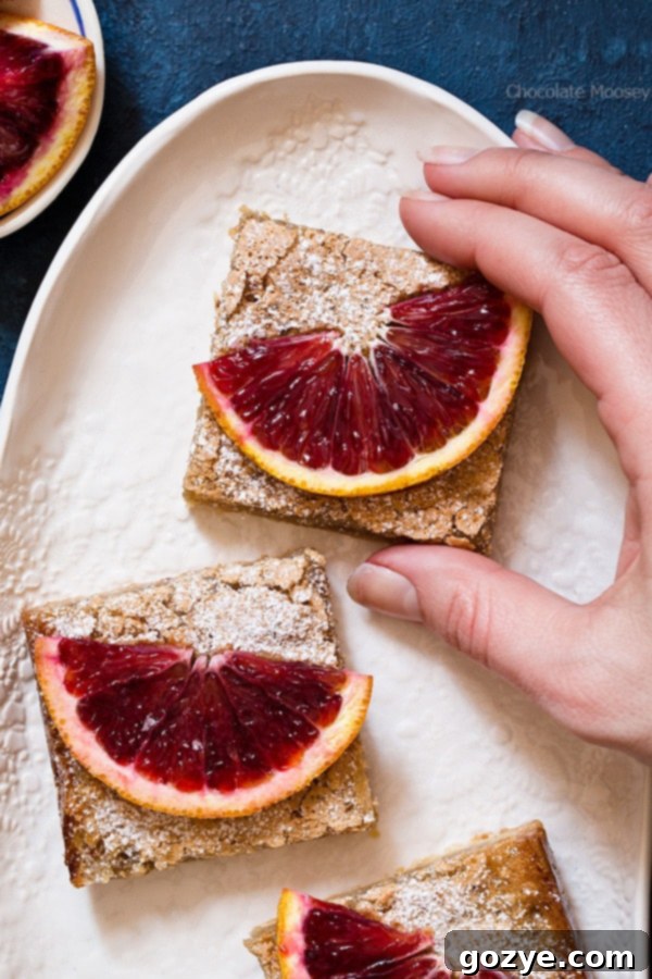 Close-up of blood orange slices with their intense red juice, illustrating the potential for messiness when preparing them.