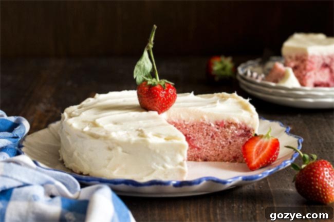 Small 6 Inch Strawberry Cake made from scratch using fresh strawberries. No cake mix and no strawberry jello! The cake cooling on a wire rack after baking.
