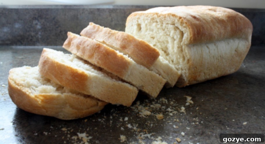 Freshly baked homemade white bread loaves cooling on a rack, ready for breakfast.