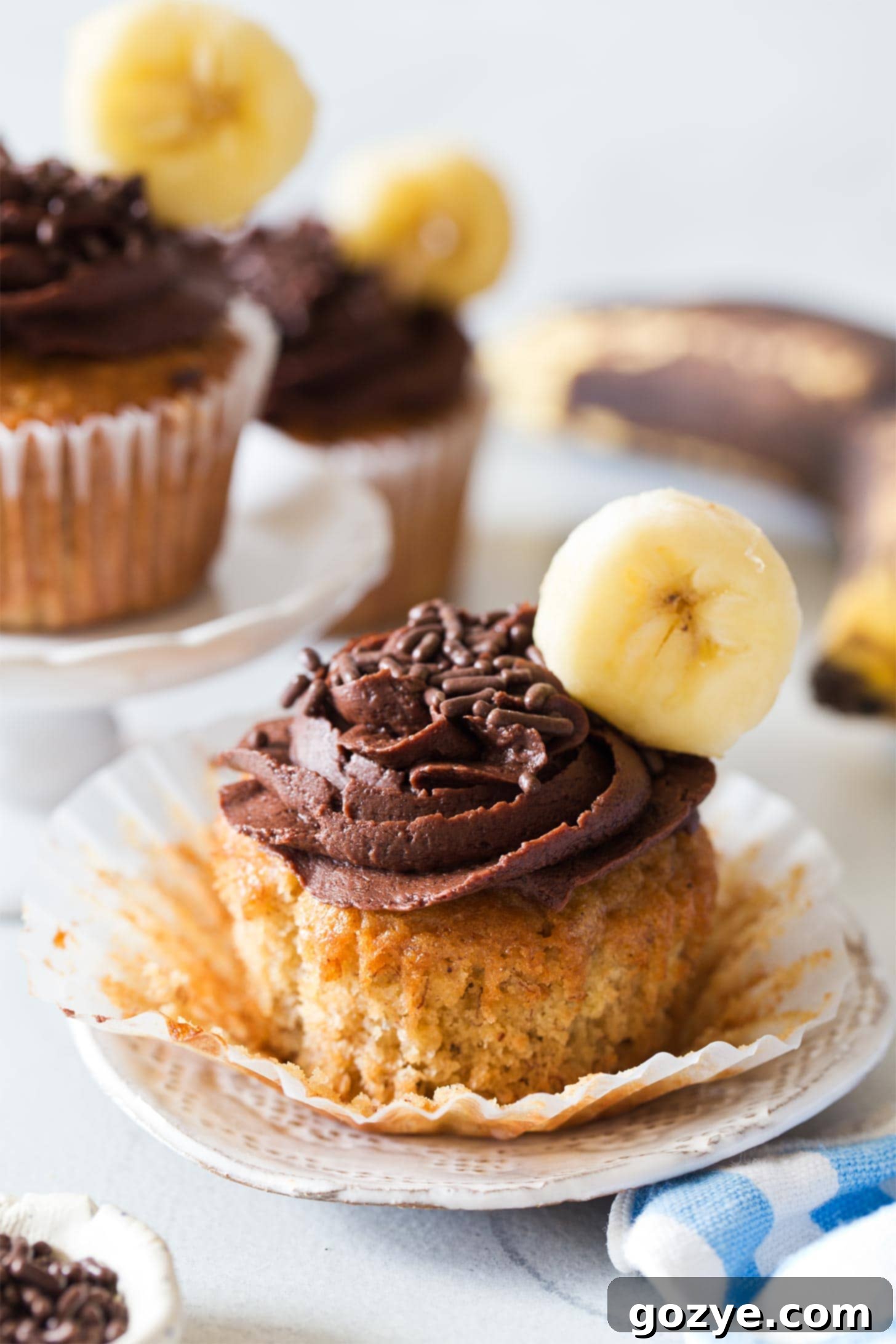 Unwrapped banana cupcake with chocolate frosting