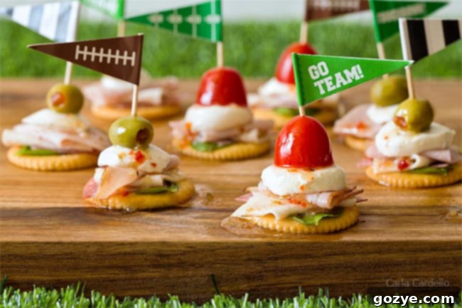 Antipasto Football Cracker Stacks arranged on an astroturf tablecloth with football toothpicks
