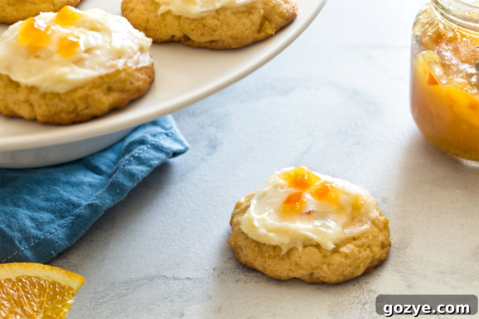 Orange Frosted Cookies with blue linen