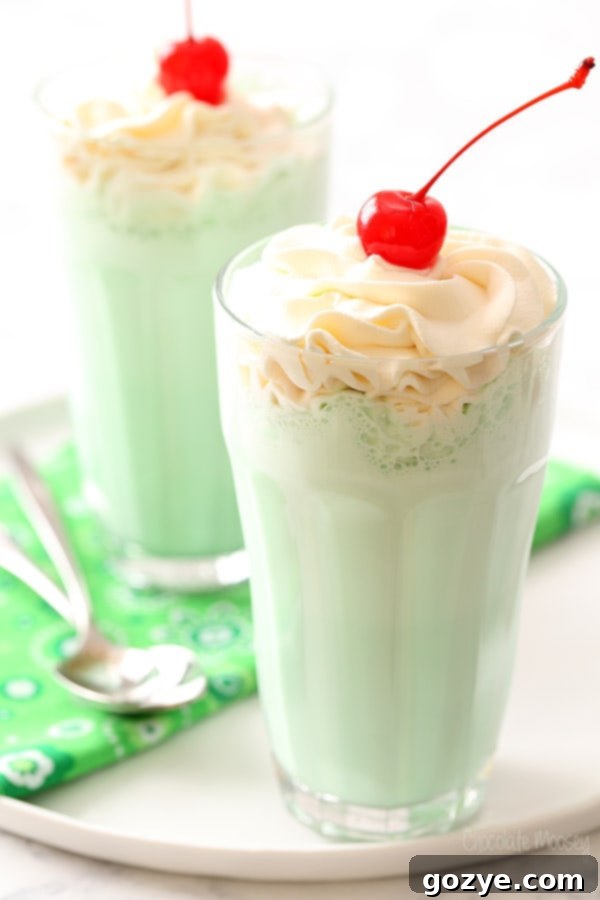 Copycat McDonald's Shamrock Shake with optional Irish Cream Whipped Cream, a vibrant green mint milkshake