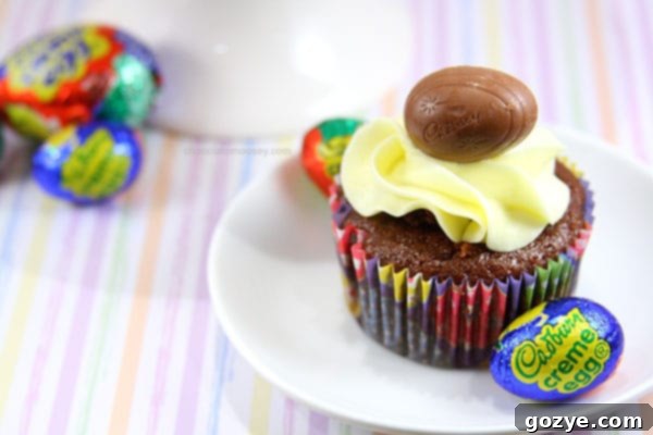 Adding yellow food coloring to the fondant cream to create the egg yolk effect
