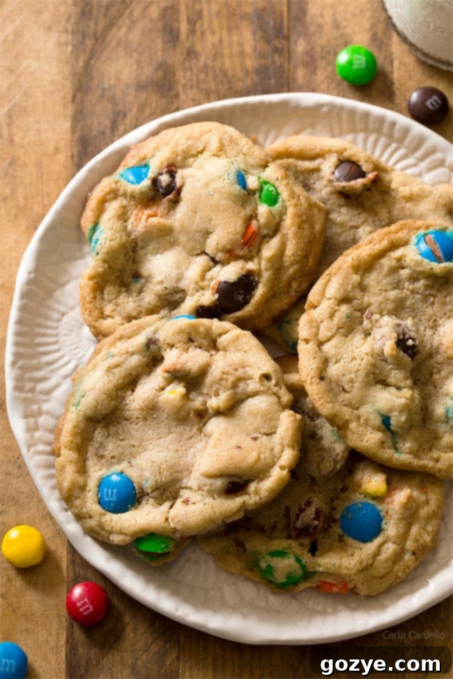 Close-up of a soft and chewy Small Batch M&M Cookie, showing its delicious texture.