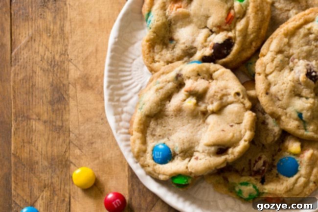 Scooped Small Batch M&M Cookie dough balls with M&Ms, arranged on a baking sheet, ready for baking.