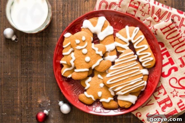 Small batch gingerbread cookie dough cut into festive Christmas shapes, ready for baking