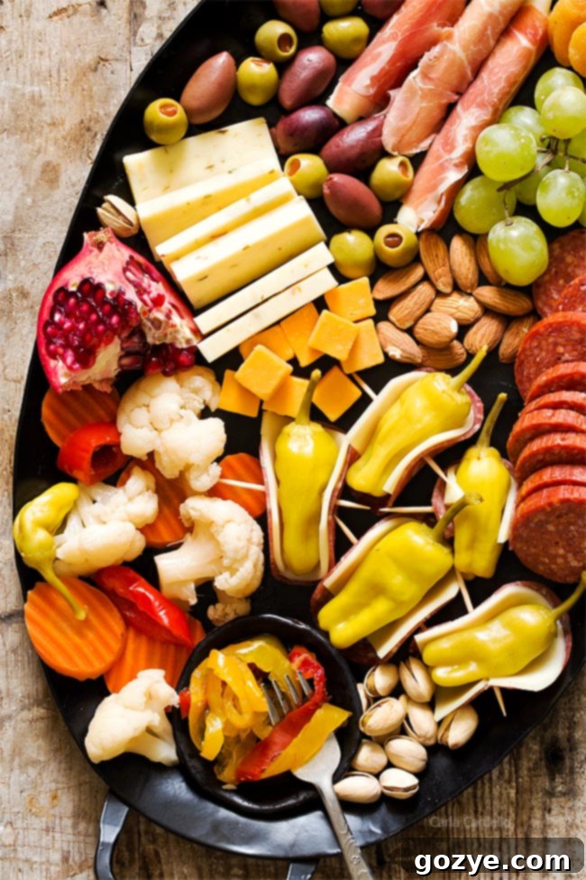 Zesty Salami Pepperoncini Rolls 6 Cheeseboard featuring Salami Wrapped Pepperoncini along with other snacks