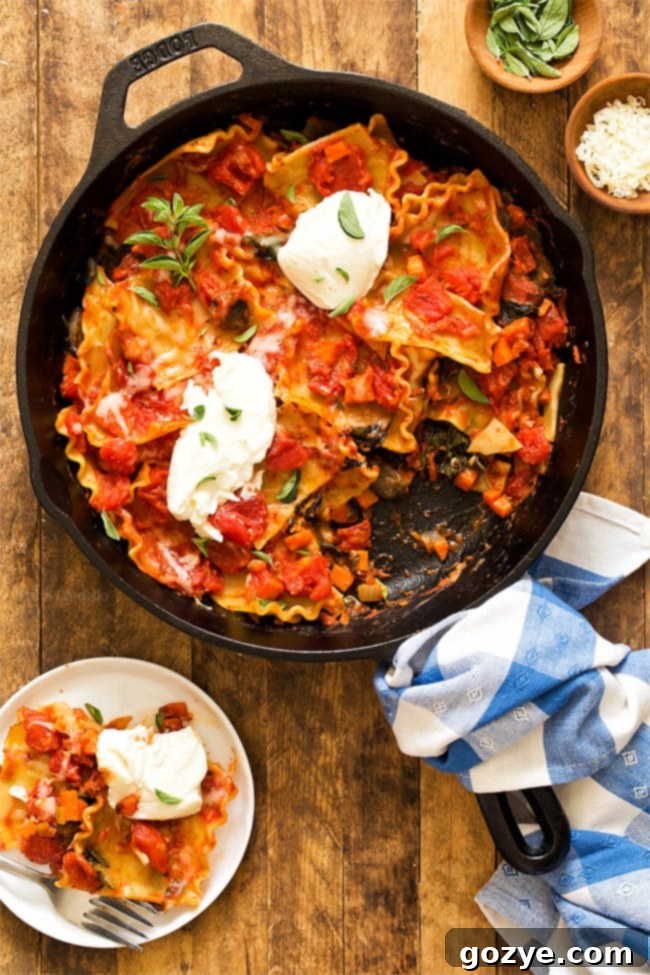 Skillet Lasagna with a slice cut out, showcasing layers of noodles, sauce, and cheese