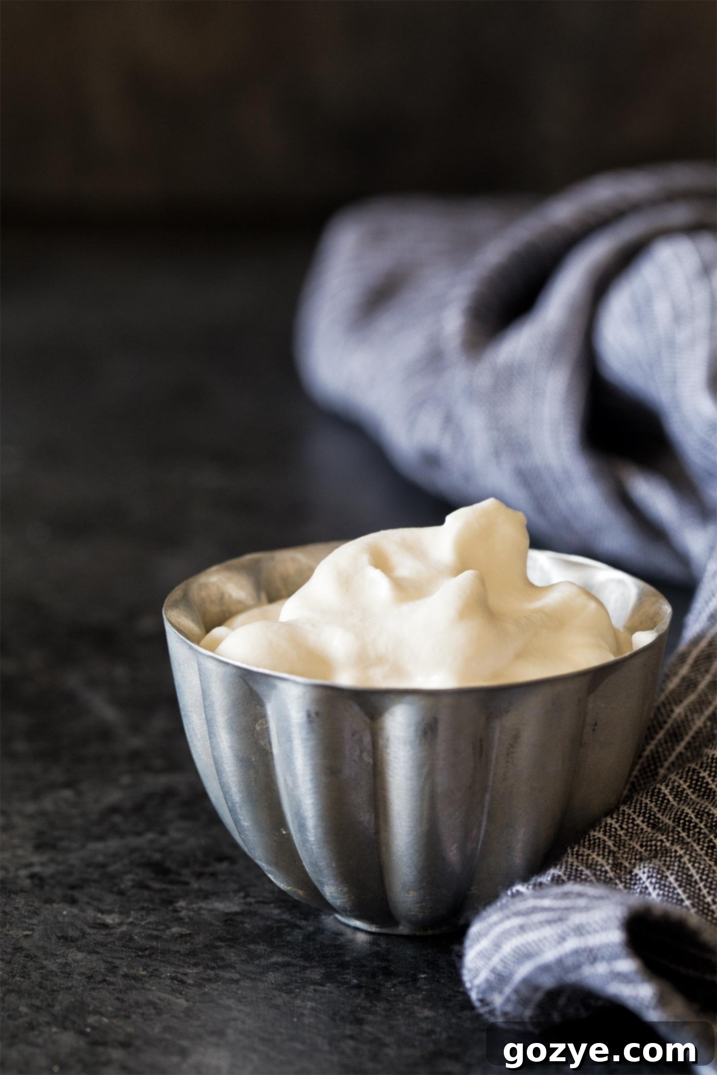 Homemade whipped cream in a silver bowl