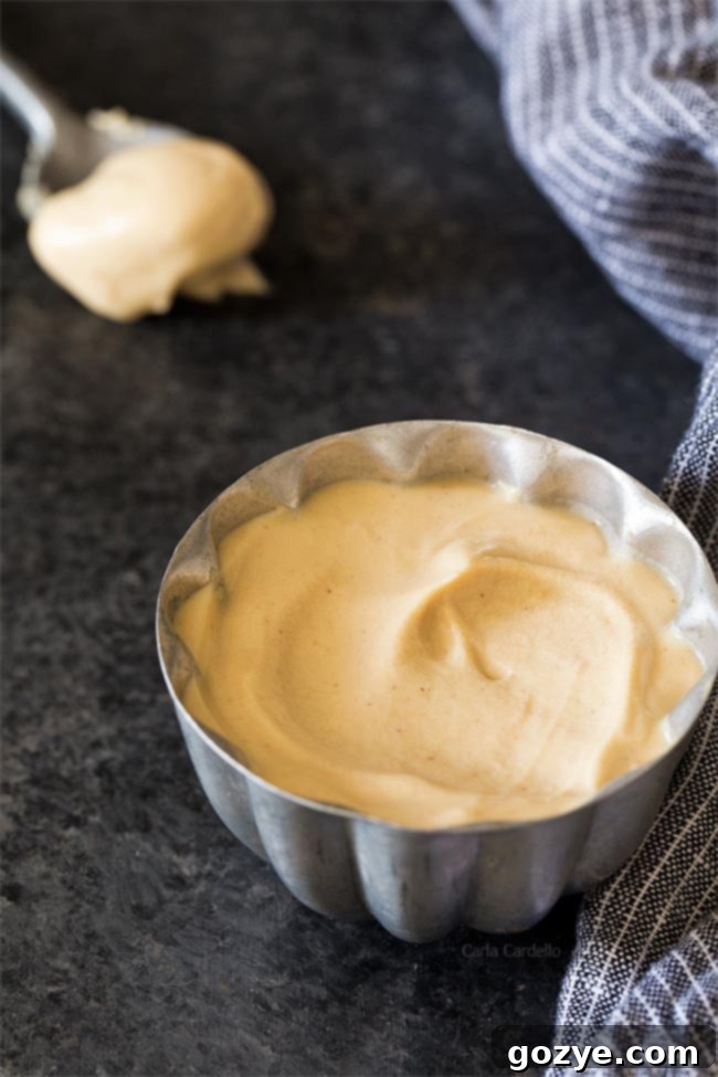 Creamy peanut butter whipped cream in a small silver bowl, ready to serve