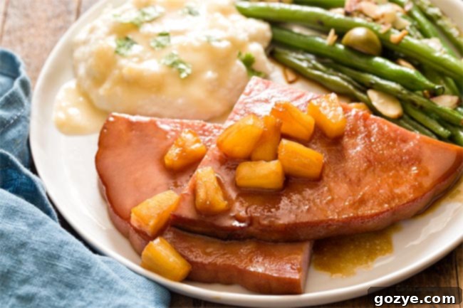 Easy Honey Glazed Ham Steak 4 A close-up of the Honey Glazed Ham Steak dinner, highlighting the glaze and pineapple tidbits.