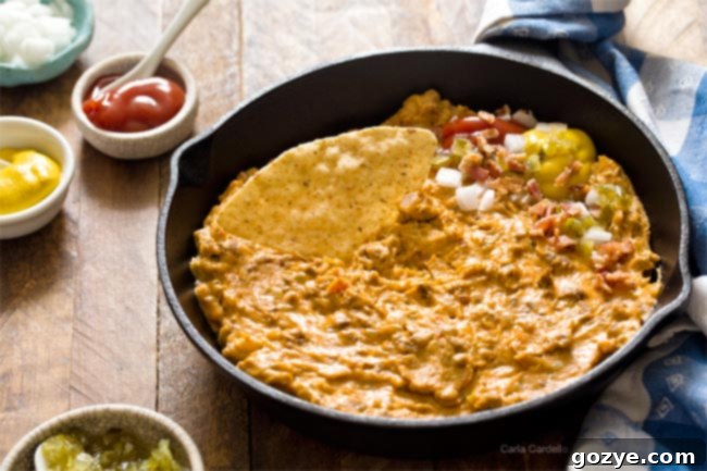 Cheesy Bacon Cheeseburger Dip (Small Batch) melting in a skillet