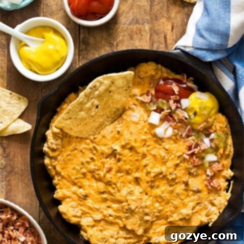 Creamy Skillet Bacon Cheeseburger Dip (Small Batch) in a skillet with a serving spoon
