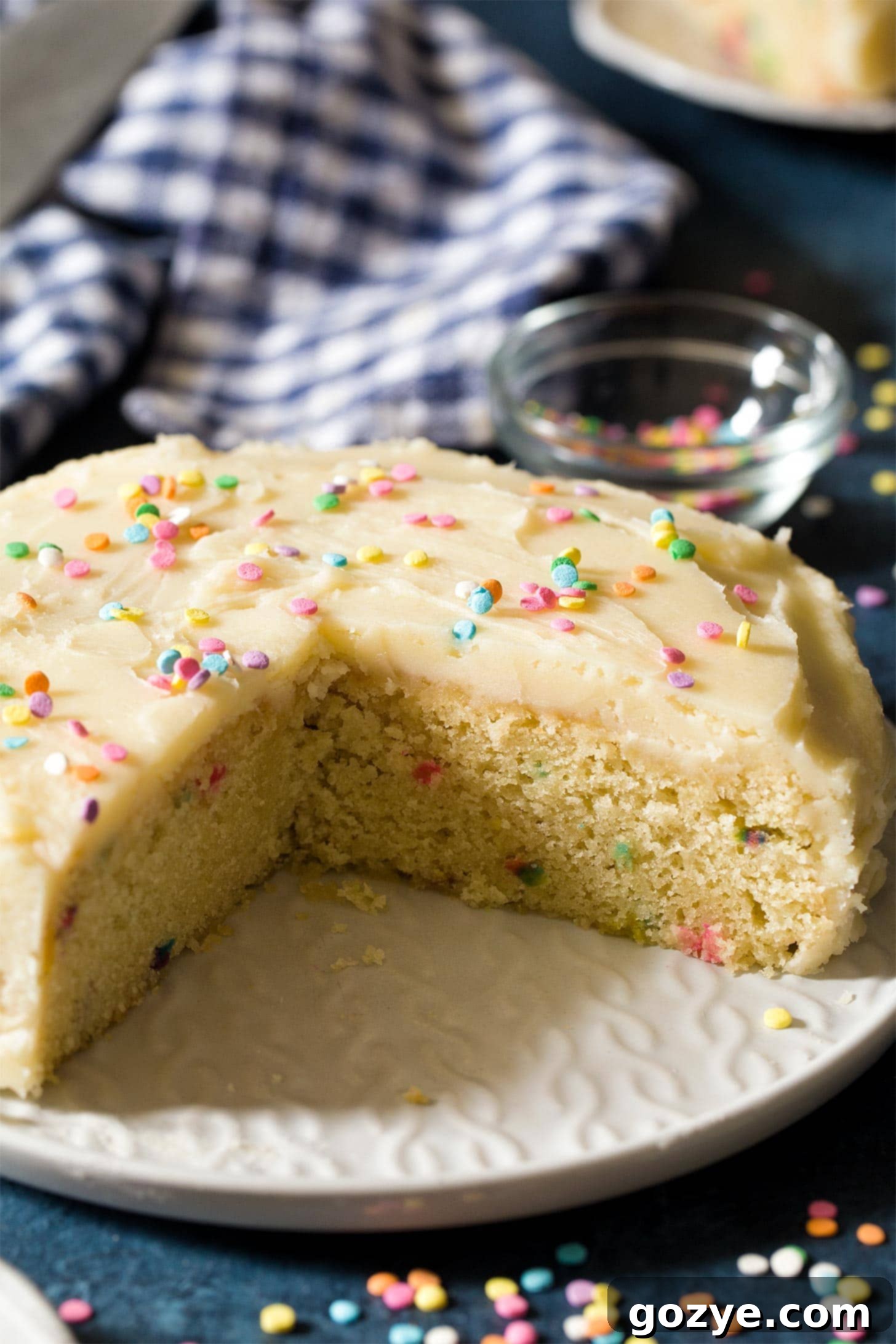 Close up of small birthday cake with slices cut