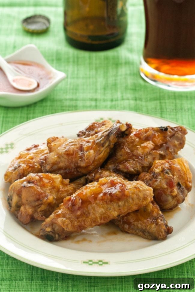 Plate of sweet chili wings on green tablecloth