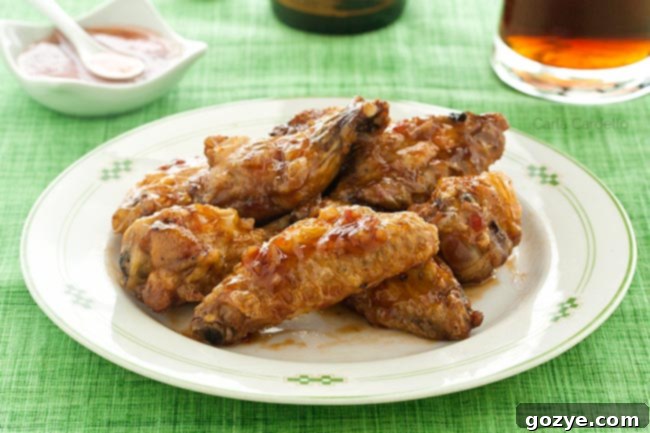 Plate of sweet chili wings on green tablecloth
