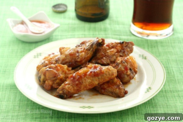 Plate of sweet chili wings on green tablecloth