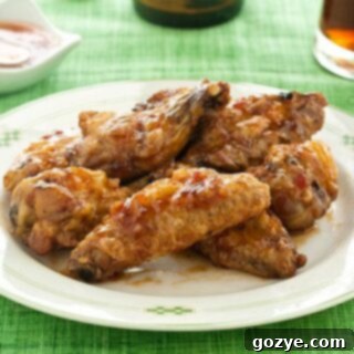 Plate of sweet chili wings on green tablecloth