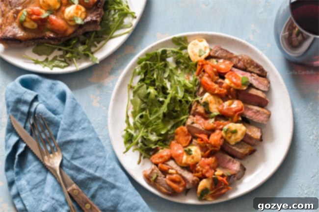 Sliced steak on plate with salad