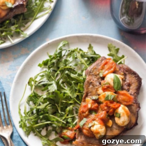 Steak dinner on plate with arugula salad