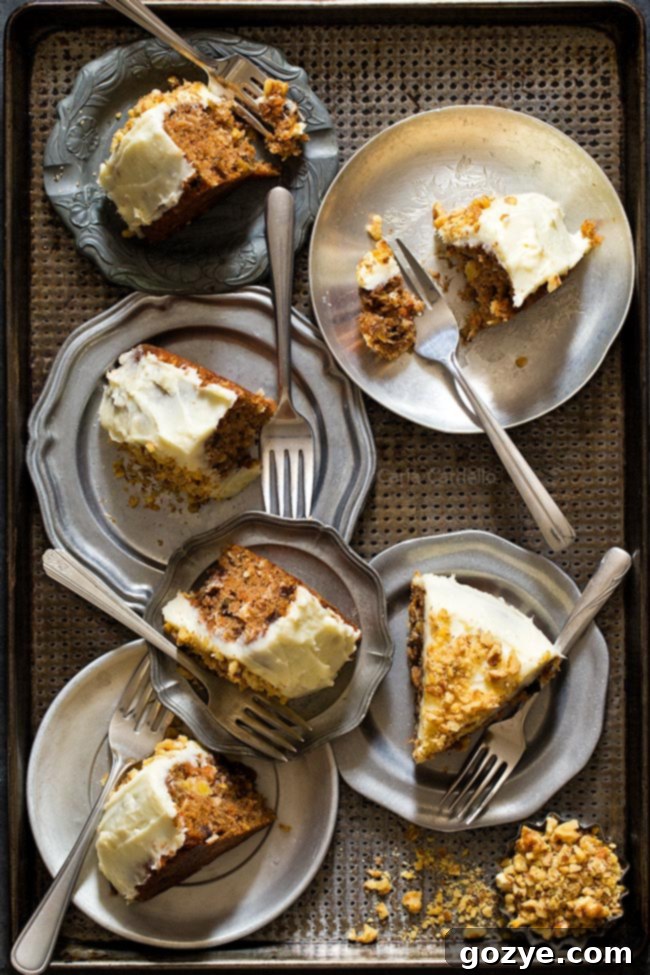 Two slices of small carrot cake on a tray, showcasing its moist texture and mix-ins