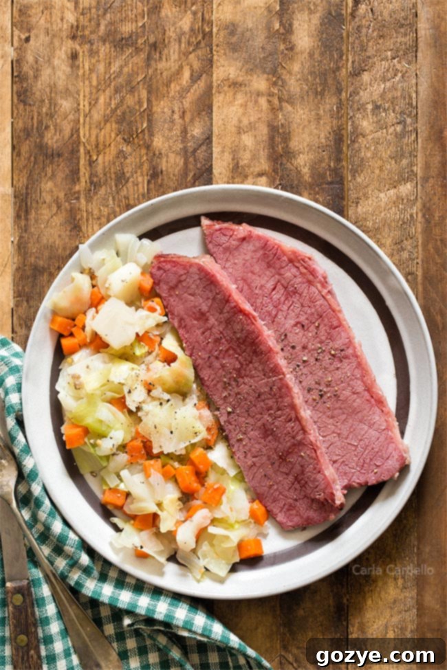 A close-up shot of Corned Beef and Cabbage served on a brown plate, garnished with a green napkin, ready for a festive meal.