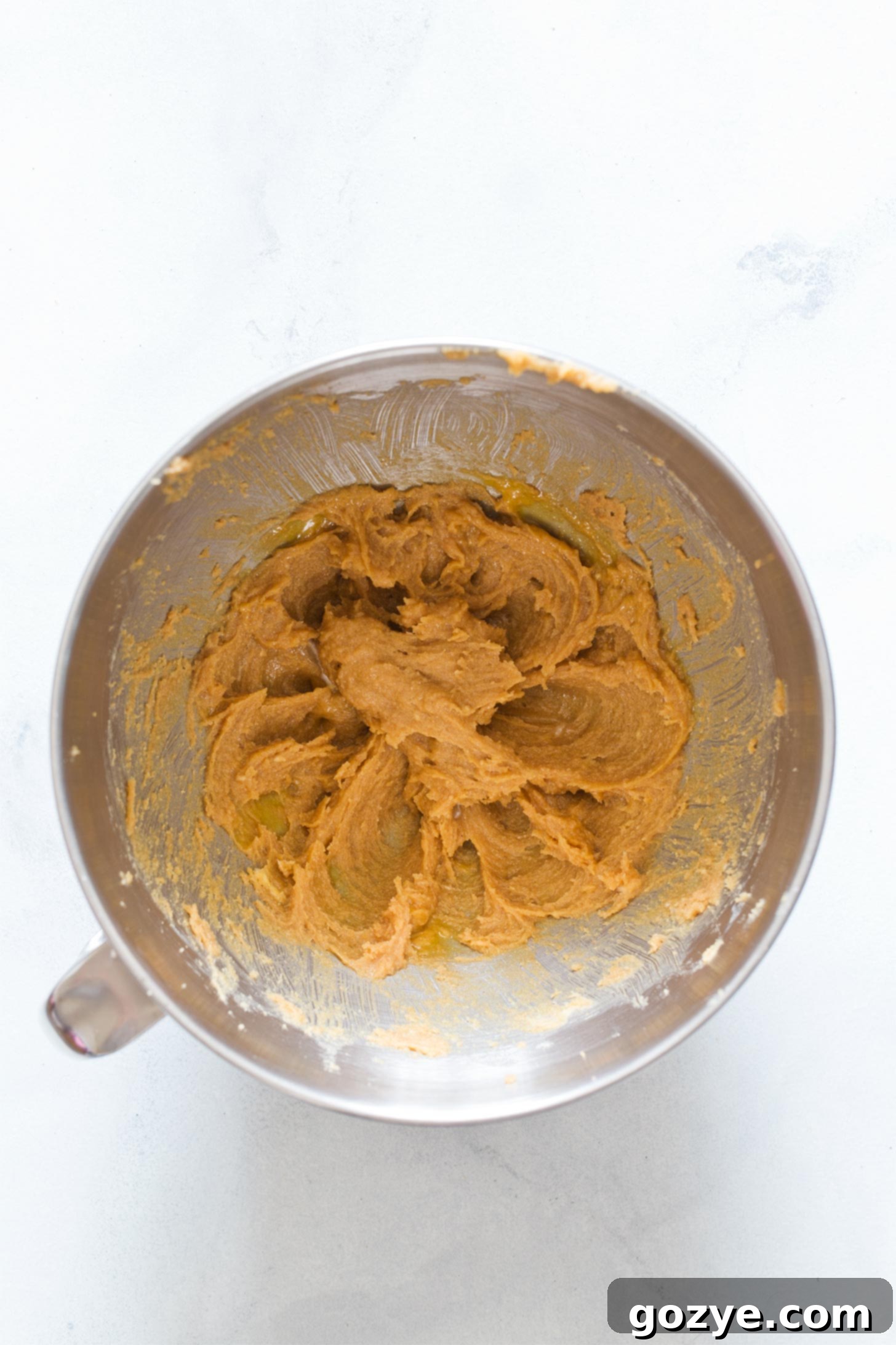 Creaming together butter and sugar to make peanut butter cookies