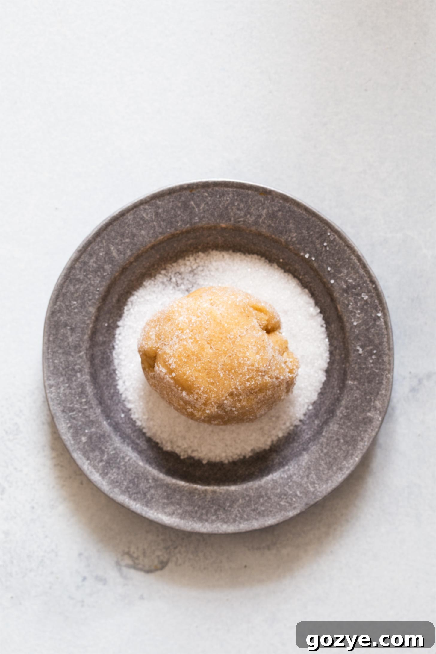 Rolling peanut butter cookie dough in sugar