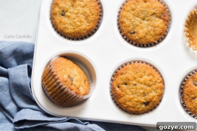 Close up of banana muffins in a stack on a white background