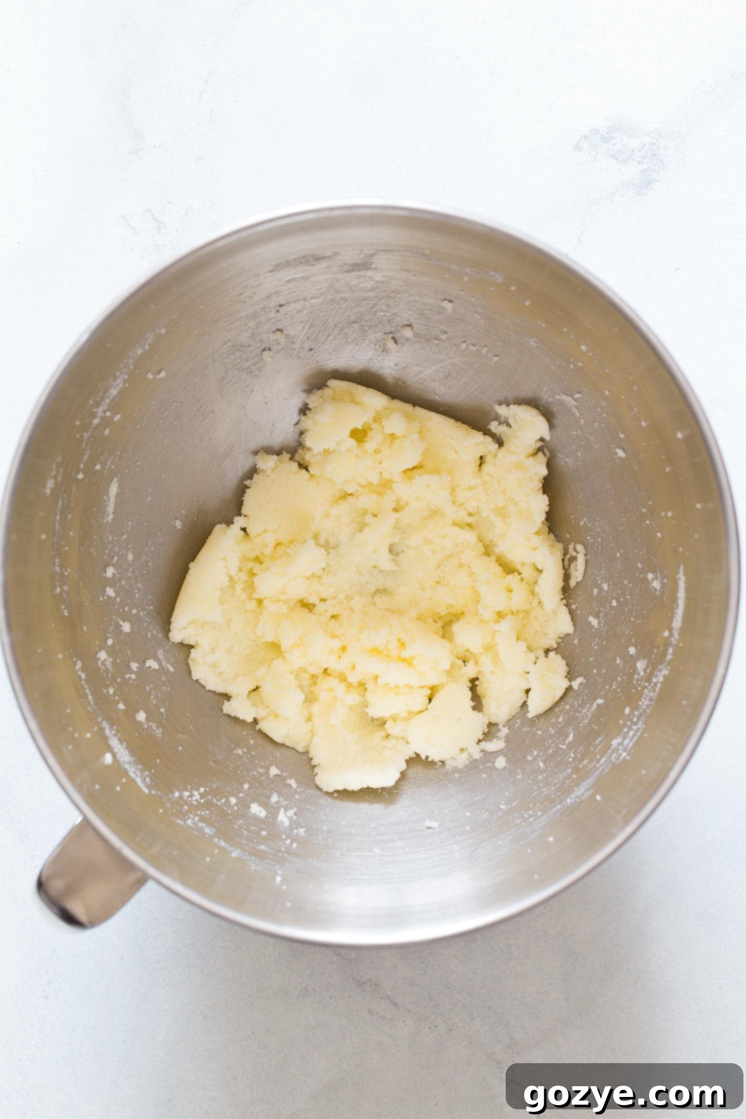Creaming butter and sugar for small batch banana muffins in a mixing bowl