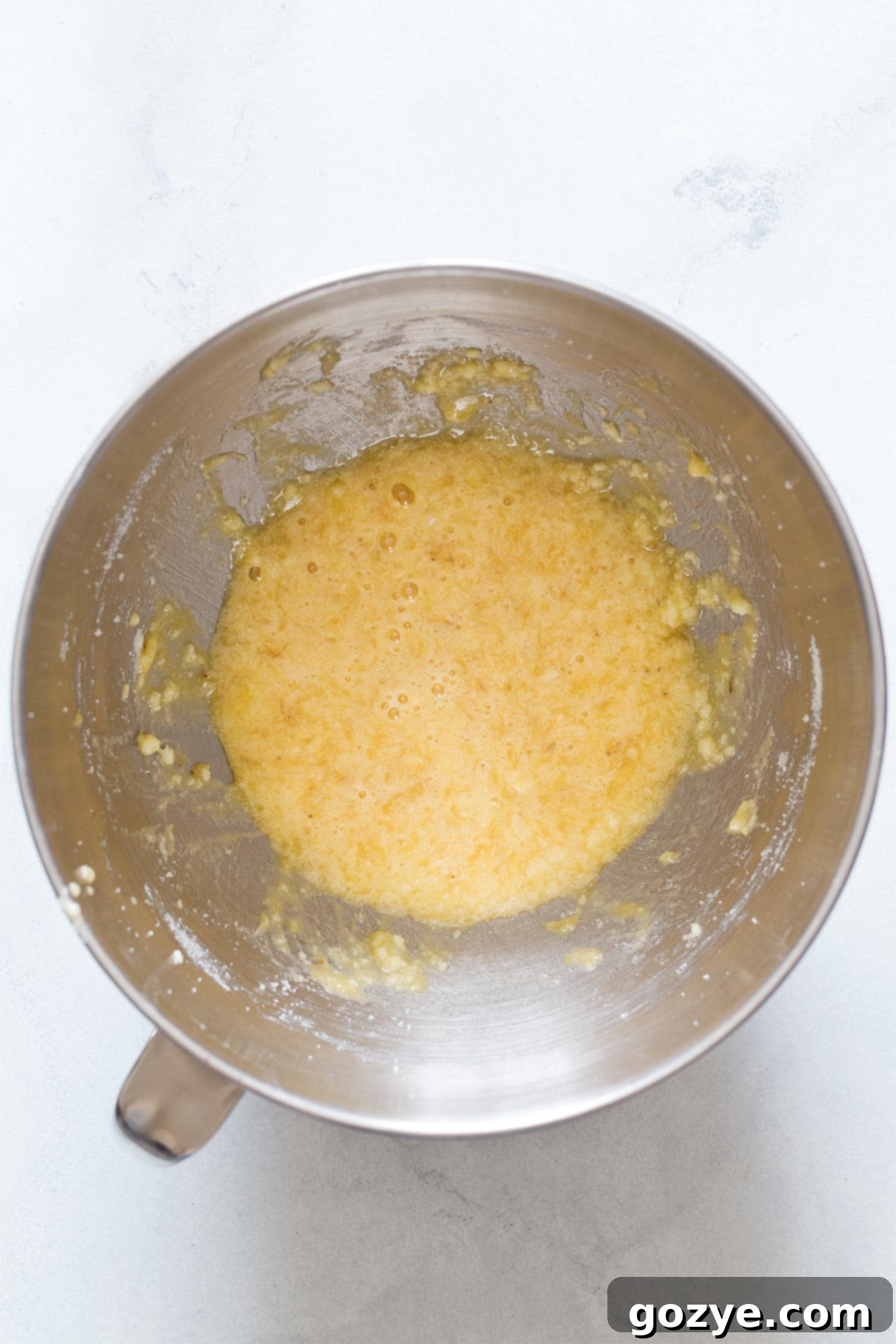 Adding egg, mashed banana, and vanilla to the creamed mixture