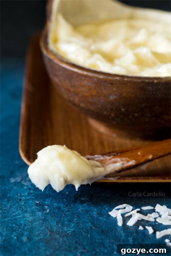 Creamy Coconut Buttercream Frosting on a spoon, ready to be enjoyed