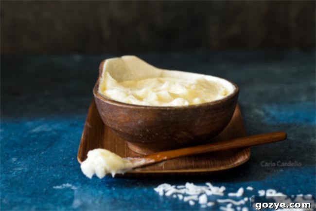 Close-up of coconut milk frosting in a small brown bowl, showcasing its creamy texture