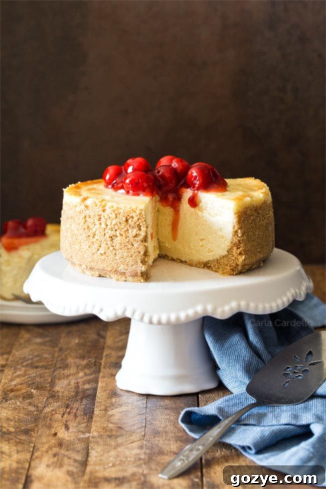 A 6 Inch Cheesecake recipe on a marble surface with a slice removed, showing its perfect creamy texture.