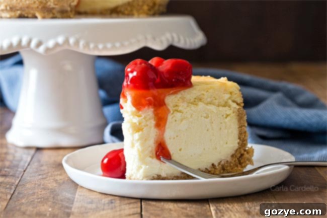 A slice of small cheesecake recipe on a plate, garnished with cherry pie filling.