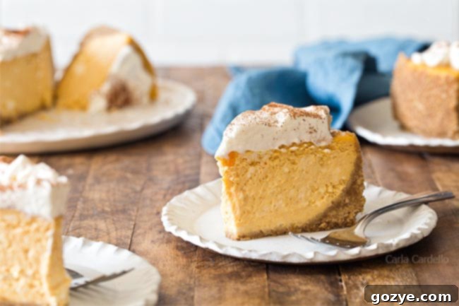 Close-up slice of small pumpkin cheesecake, garnished with cream