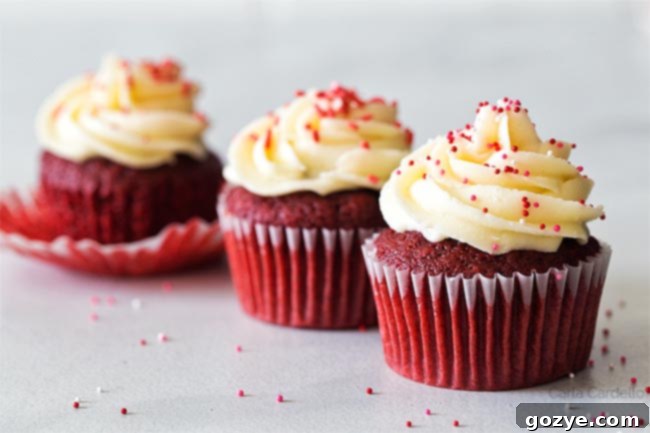 Three Red Velvet Cupcakes lined up, showcasing their vibrant color and frosting