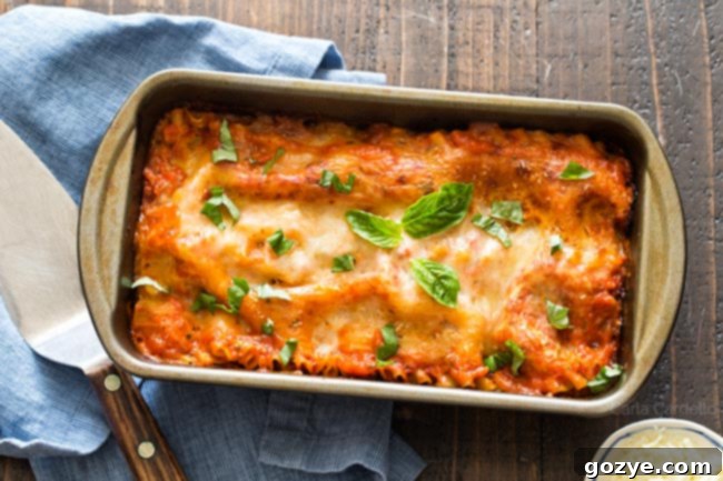Close-up of a loaf pan with unbaked lasagna layers visible, showing the precision of small batch cooking