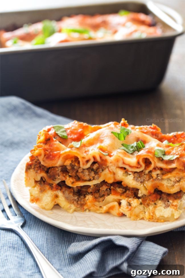 Close-up of a single slice of beef lasagna for two, showing the distinct layers of pasta, meat, and ricotta