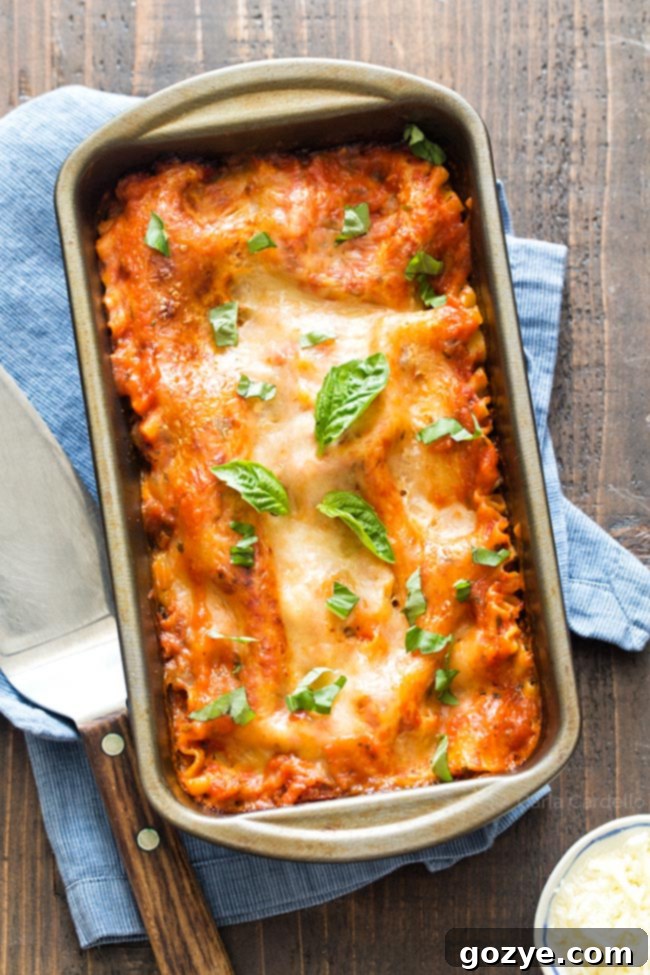 Overview of a loaf pan with carefully arranged lasagna layers before baking, ready for the oven