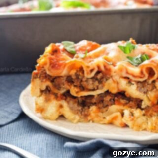 Perfect slice of Lasagna For Two served on a white plate