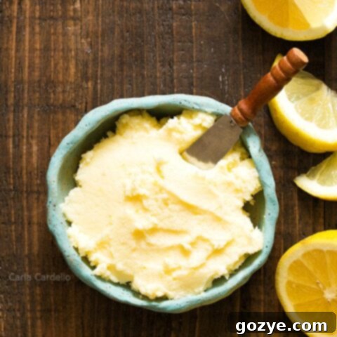 Blue bowl of Lemon Buttercream Frosting with lemon slices, featured in the recipe card