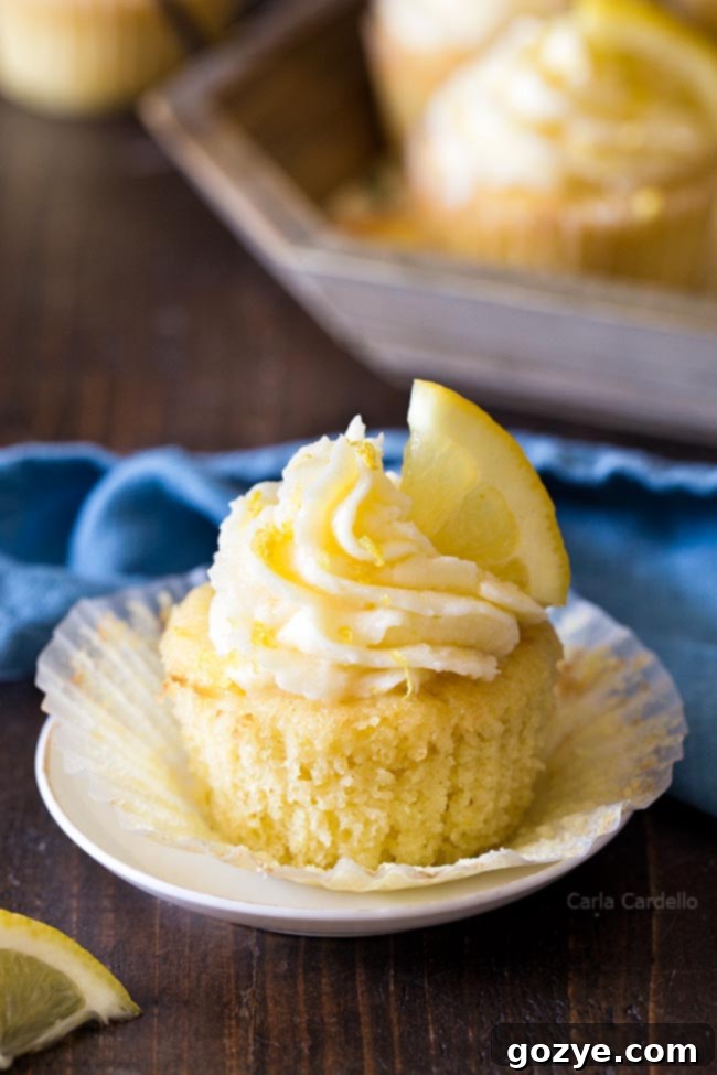 Easy Small Batch Lemon Cupcakes 6 An unwrapped small batch lemon cupcake, showcasing its golden-brown top and fluffy interior, ready for its luscious frosting.