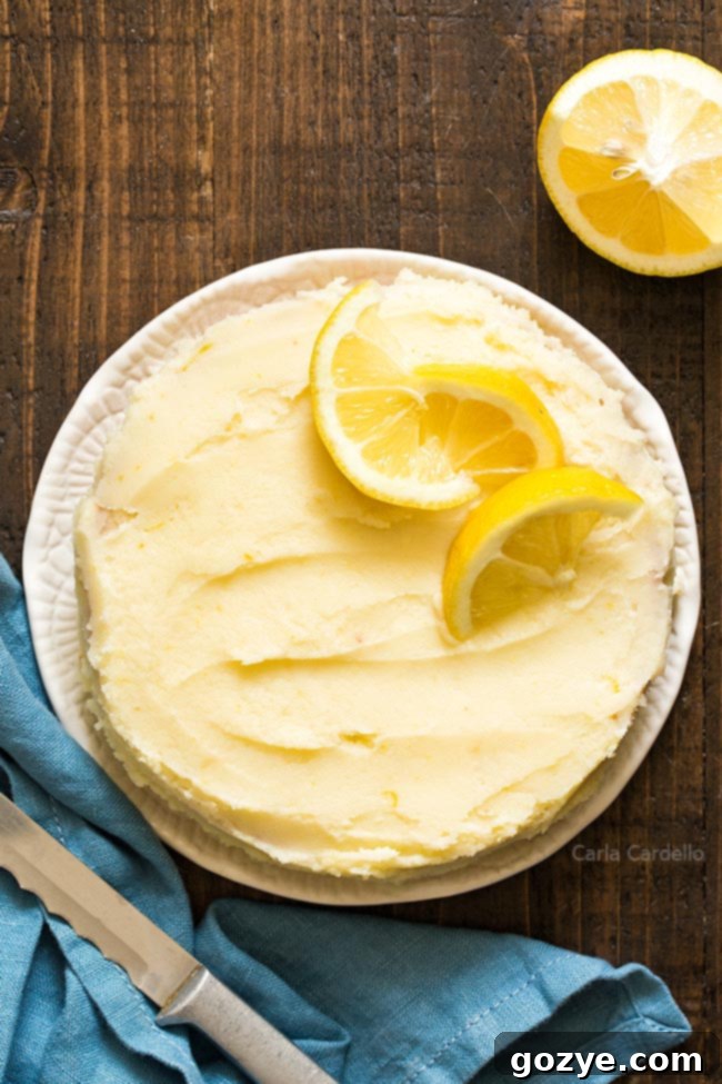 Small lemon cake with a knife and fresh lemon half