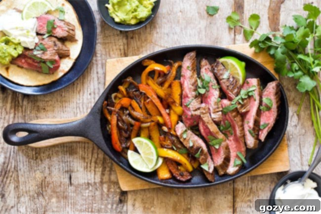 Perfectly cooked steak and vibrant peppers in a cast iron pan, ready for serving