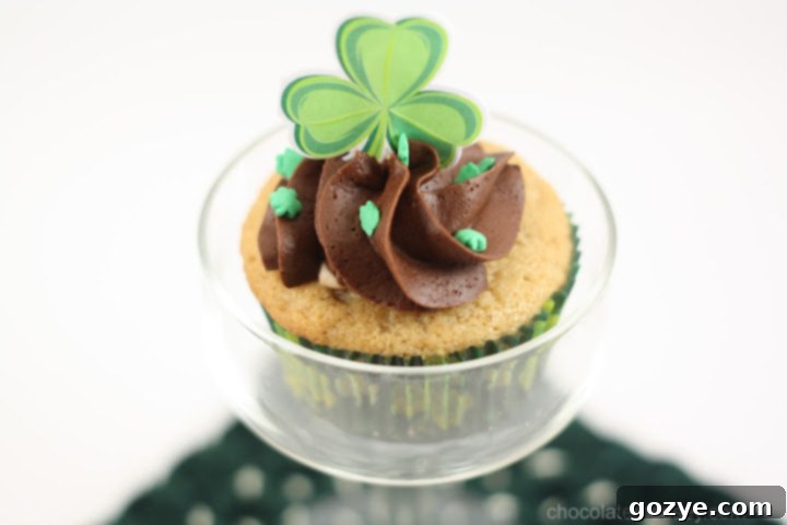 Decadent Irish Cream Cupcakes topped with Irish cream frosting and chocolate shavings