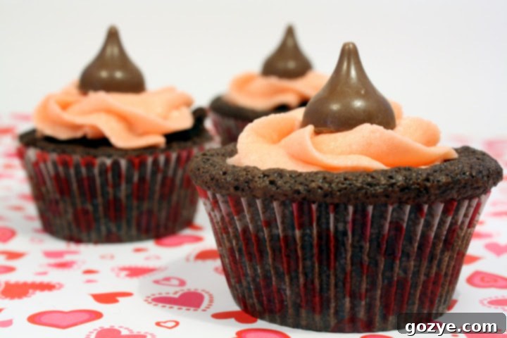 Rich Chocolate Cherry Brownie Cupcakes with a vibrant cherry buttercream and a fresh cherry garnish