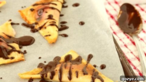Baked Cherry Cheesecake Wontons with a bowl of chocolate dipping sauce