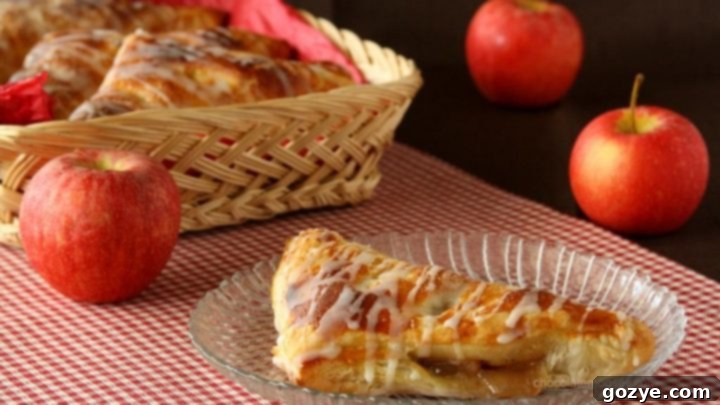 Freshly baked golden apple turnovers with a dusting of powdered sugar